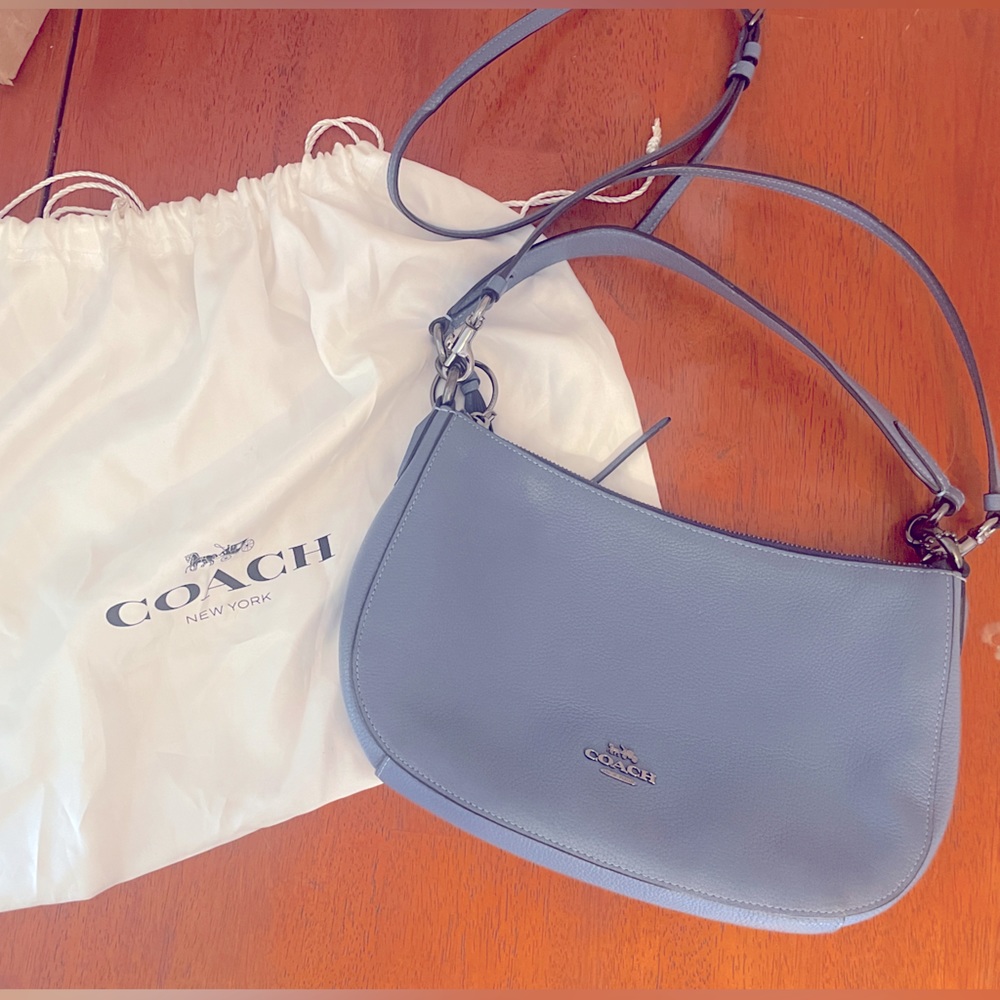 NEW. Never used Blue Coach bag WITH duster.